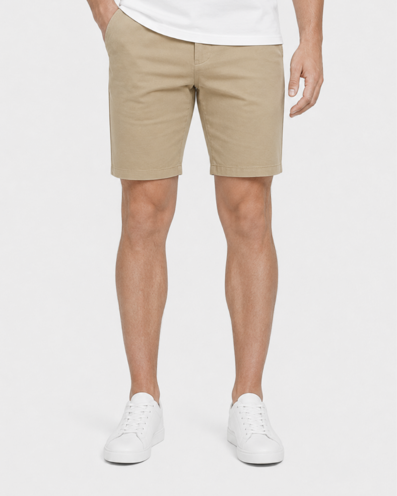 Person wearing Grant Oak beige shorts and white sneakers on a plain background #Color_beige