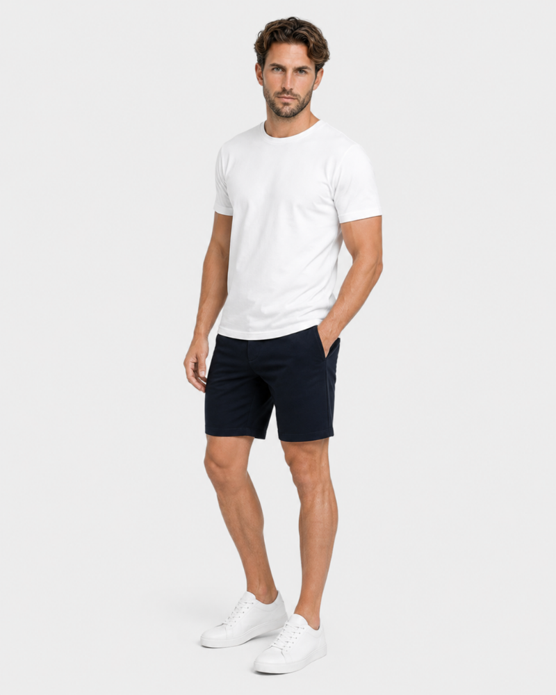 Grant Oak navy shorts on male model front angle full body view light gray background #color_navy