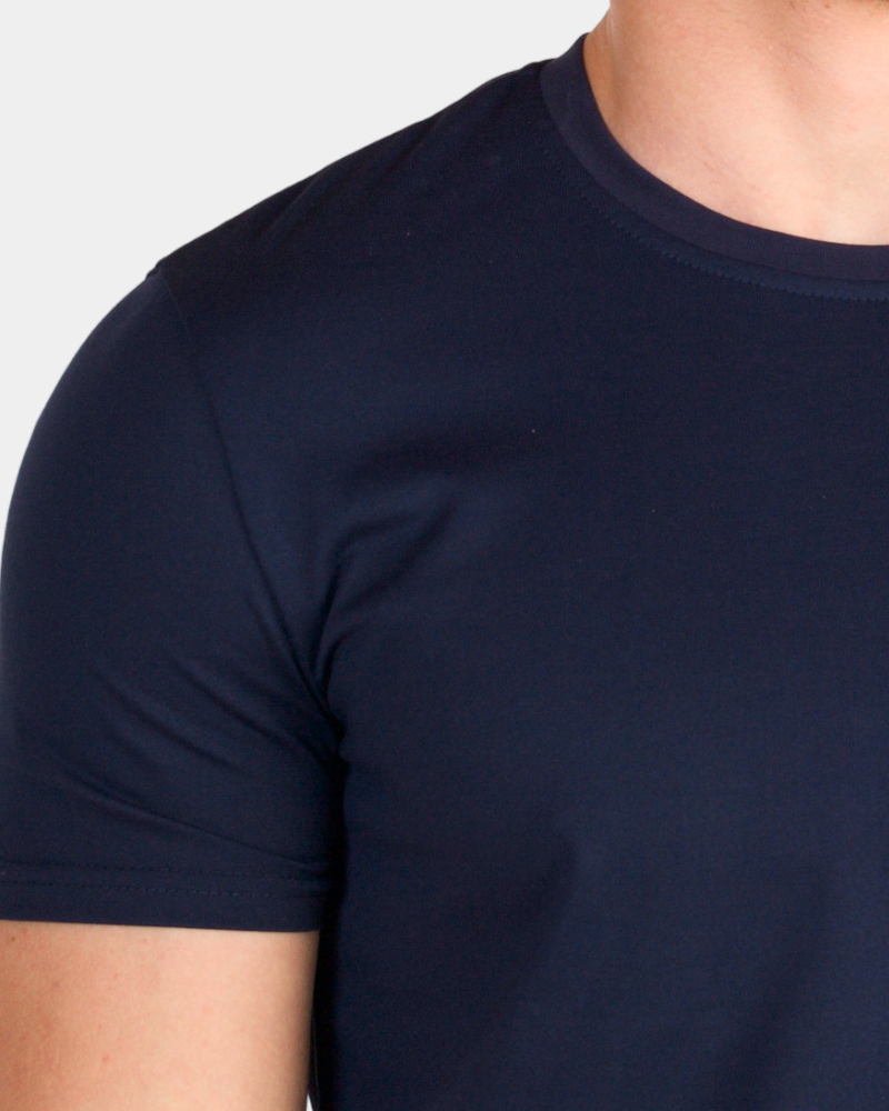 Grant Oak navy crew neck t-shirt on male model, close-up shoulder detail, gray background #Color_navy