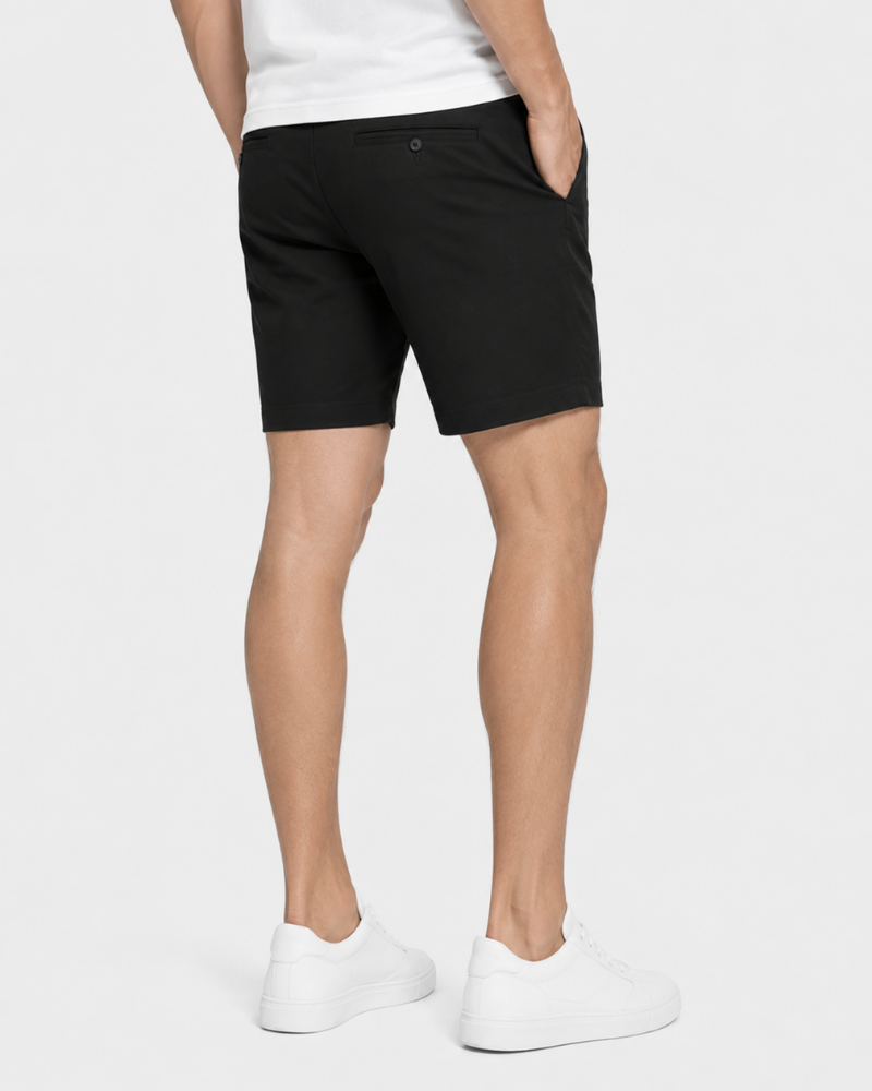 Person wearing Grant Oak black shorts and white shoes back view on a white background #Color_black
