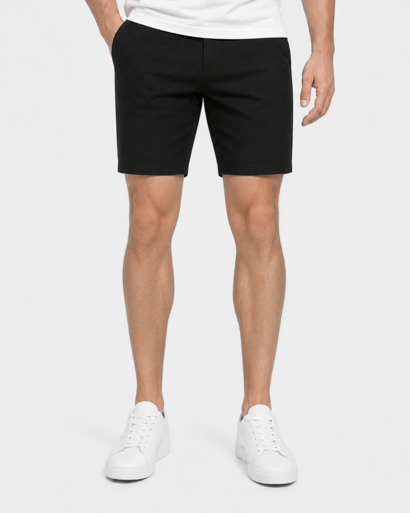 Person wearing Grant Oak black shorts and white sneakers on a white background #Color_black