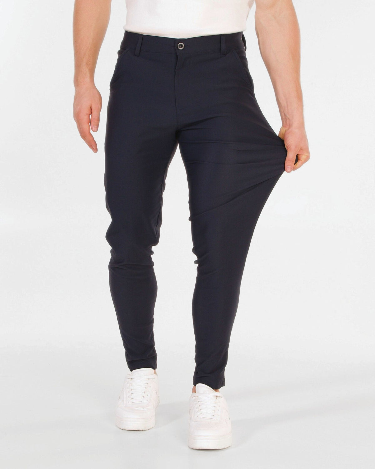 Grant Oak Smart Fit Chinos 4-Pack Essentials — person wearing navy chinos and white sneakers on a white background.
