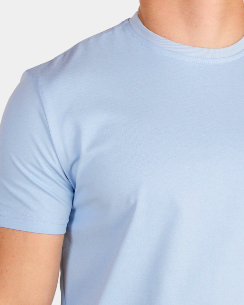 Grant Oak light blue crew neck t-shirt on male model, close-up shoulder detail, gray background #Color_light blue