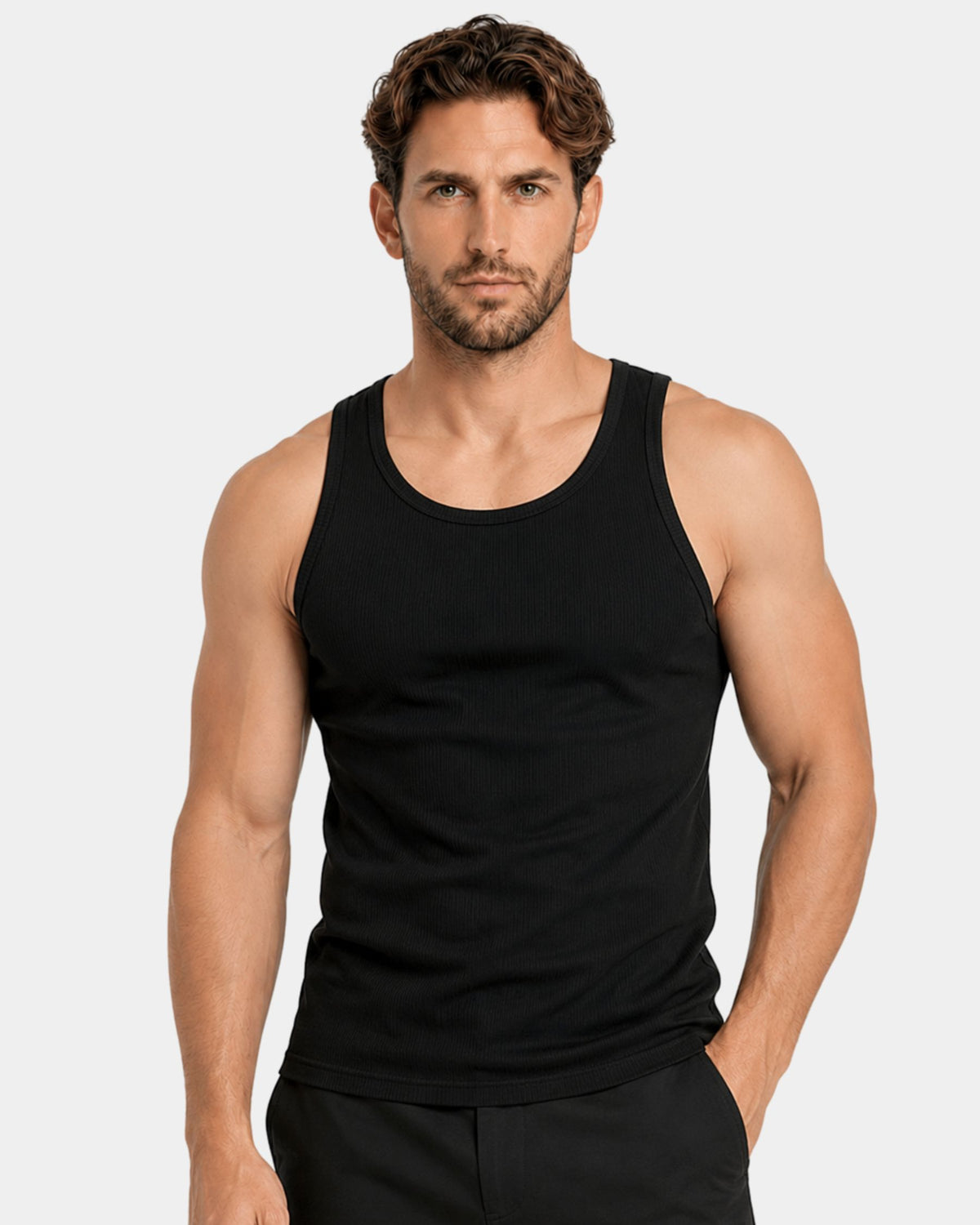 Grant Oak Smart Fit Tank 6-Pack Mixed — muscular man wearing a black sleeveless tank top and black pants against a light gray studio background.